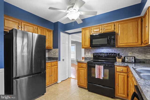 kitchen featuring sink, tasteful backsplash, ceiling fan, and black appliances