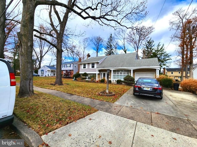 view of front facade with a garage and a front lawn