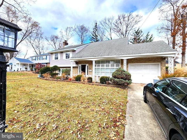 view of front facade with a front yard and a garage