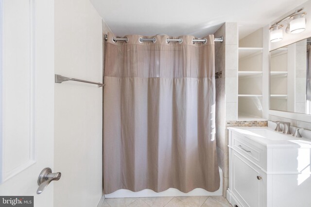 bathroom featuring tile patterned flooring, shower / tub combo with curtain, and vanity