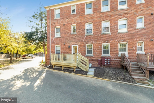 multi unit property with a deck and brick siding