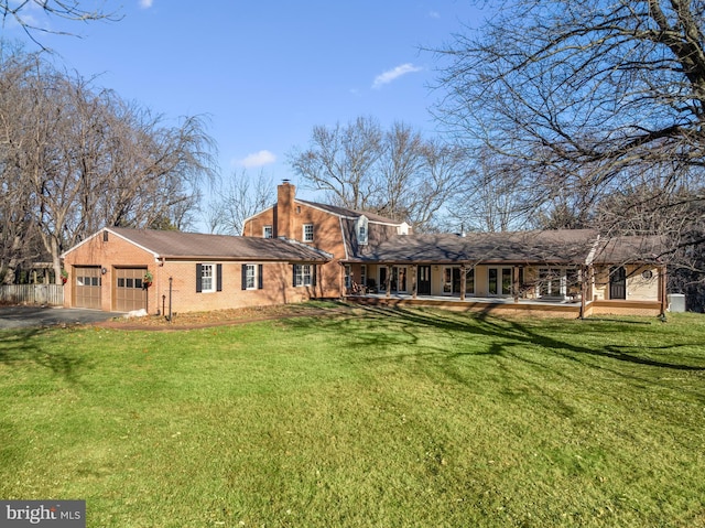 rear view of property with a yard and a garage