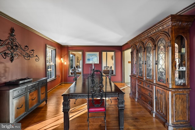 dining room featuring dark hardwood / wood-style floors and ornamental molding