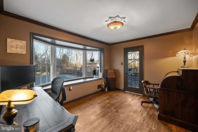 office area with hardwood / wood-style floors and crown molding