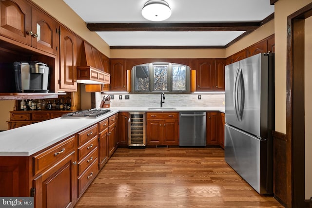 kitchen with sink, beverage cooler, dark hardwood / wood-style floors, custom range hood, and appliances with stainless steel finishes