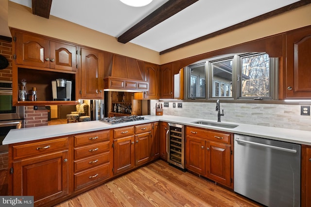 kitchen with custom exhaust hood, sink, wine cooler, light wood-type flooring, and appliances with stainless steel finishes