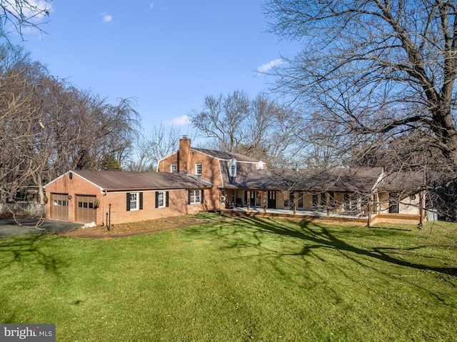 back of property featuring a lawn and a garage