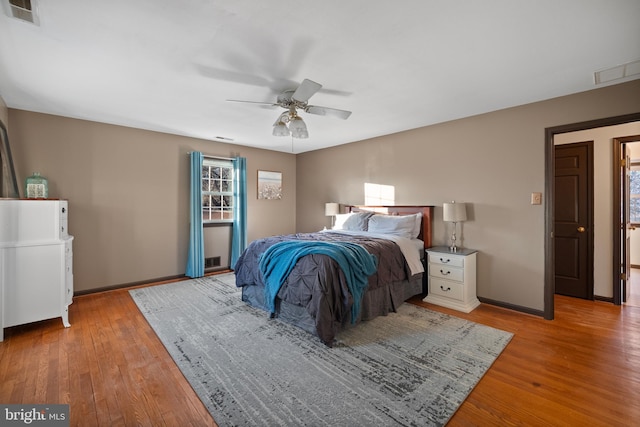 bedroom with light hardwood / wood-style floors and ceiling fan