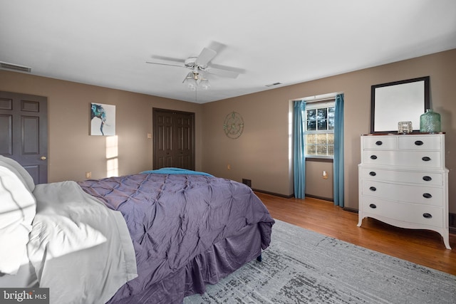 bedroom featuring ceiling fan, a closet, and light hardwood / wood-style flooring