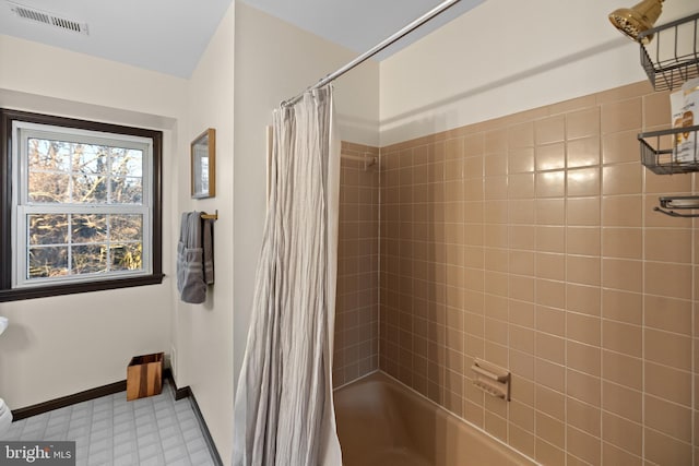 bathroom with shower / tub combo with curtain