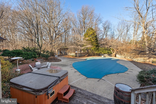 view of swimming pool with a patio area and a hot tub