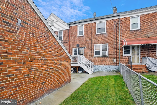 rear view of house with a lawn