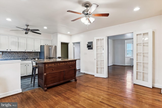 kitchen featuring white cabinetry, stainless steel fridge, french doors, and dark wood-type flooring