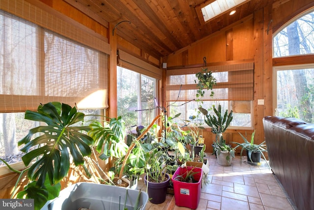 sunroom featuring wood ceiling and vaulted ceiling with skylight