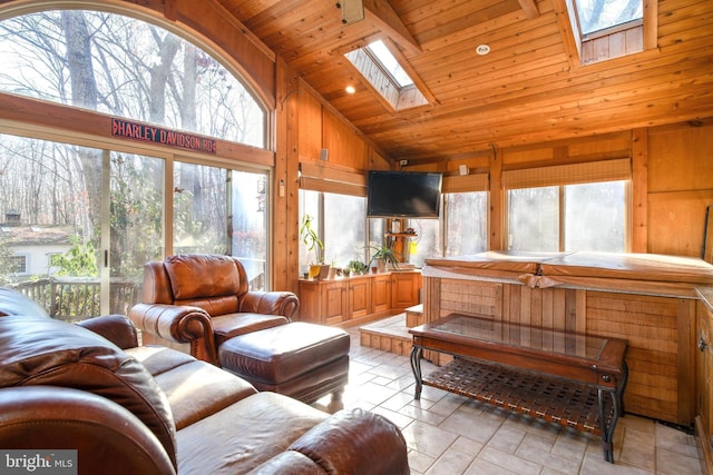 living room featuring a skylight, high vaulted ceiling, wooden ceiling, and wood walls