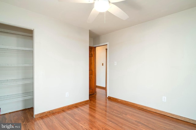 empty room with hardwood / wood-style floors and ceiling fan