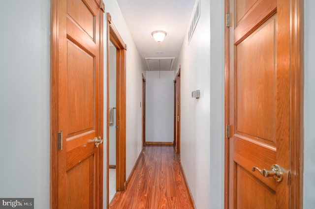 hall with hardwood / wood-style flooring