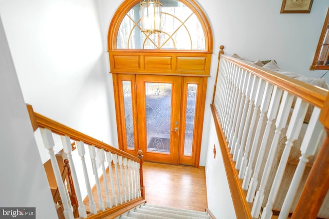 entrance foyer with wood-type flooring and an inviting chandelier