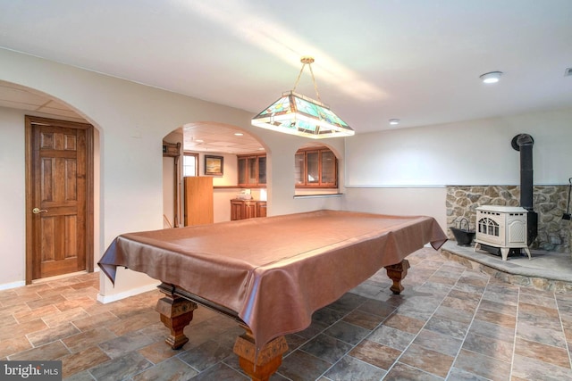 rec room with a wood stove and pool table