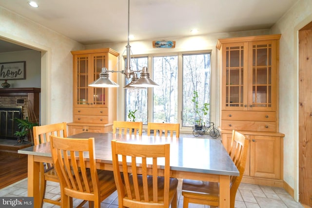 dining space with a notable chandelier and a fireplace