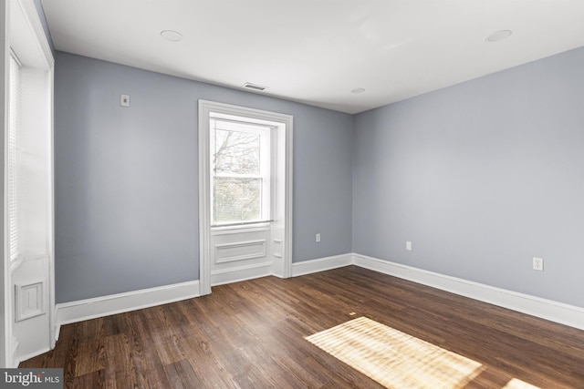 spare room with dark wood-type flooring