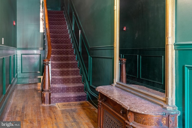 staircase with hardwood / wood-style floors