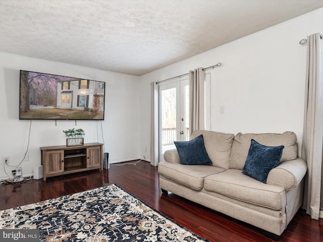 living room featuring a textured ceiling, french doors, and dark hardwood / wood-style flooring