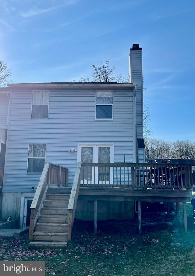 back of property with a wooden deck