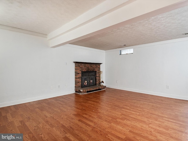 unfurnished living room with a textured ceiling, hardwood / wood-style floors, and a fireplace