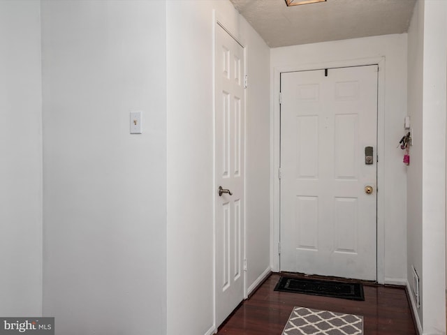 doorway to outside with dark hardwood / wood-style floors