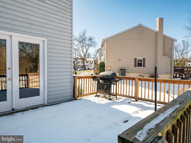 snow covered deck featuring area for grilling