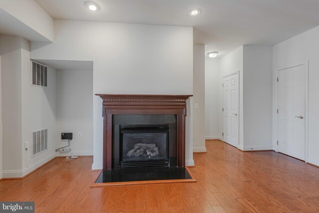 10205 Wincopin Cir Unit 405, Columbia, MD 21044 - detailed view of wood finished floors, a glass covered fireplace, and recessed lighting