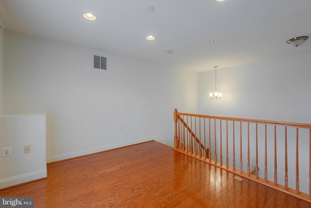 10205 Wincopin Cir Unit 405, Columbia, MD 21044 - unfurnished room featuring wood finished floors, a chandelier, and recessed lighting