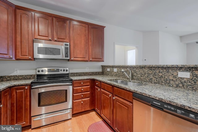 10205 Wincopin Cir Unit 405, Columbia, MD 21044 - kitchen featuring stainless steel appliances, stone countertops, and light wood-style floors