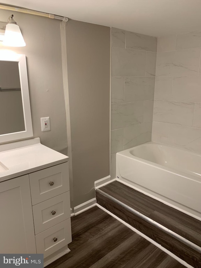 bathroom with wood-type flooring, vanity, and shower / bath combination