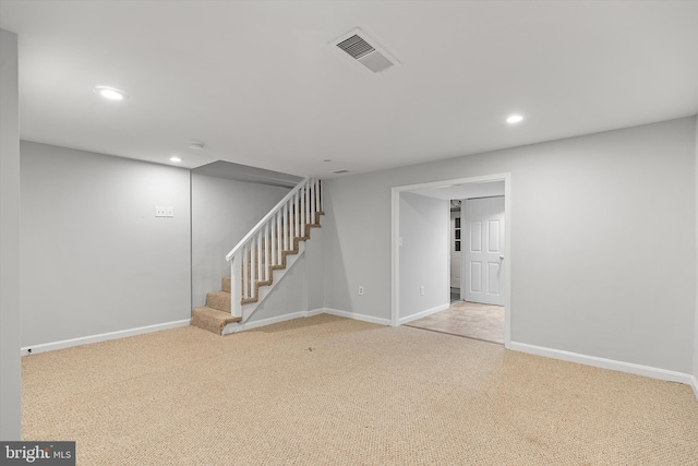 basement featuring light carpet