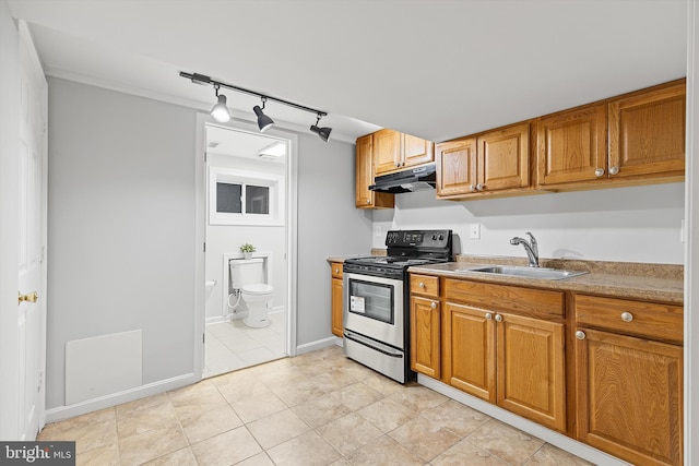 kitchen with light tile patterned flooring, sink, track lighting, and stainless steel electric range