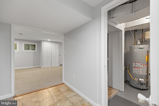 utility room featuring water heater