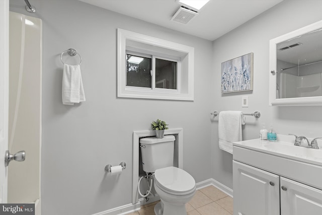 bathroom with tile patterned floors, a shower, vanity, and toilet