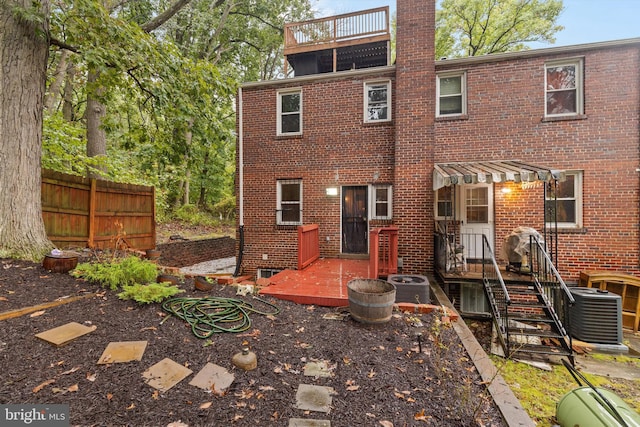 rear view of property with cooling unit