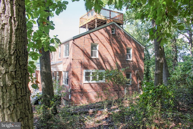 view of side of property with a balcony