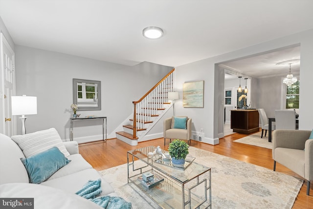 living room with a notable chandelier and wood-type flooring