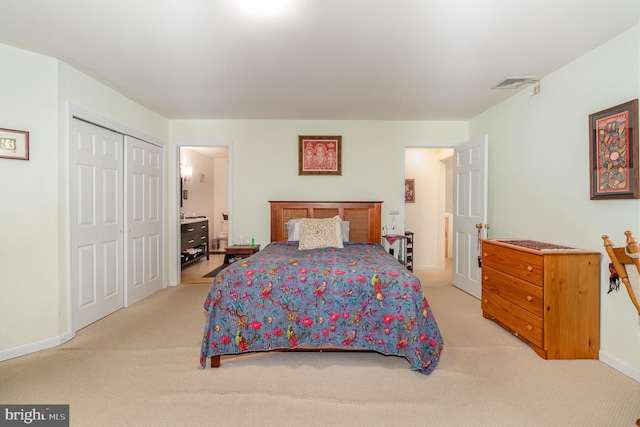 bedroom featuring light colored carpet and a closet