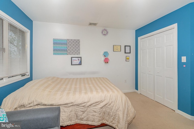 bedroom with carpet flooring and a closet