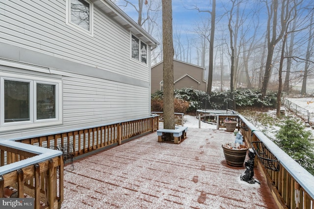 snow covered deck featuring a trampoline