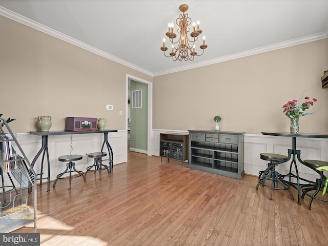 office area featuring a notable chandelier, light wood-type flooring, and crown molding