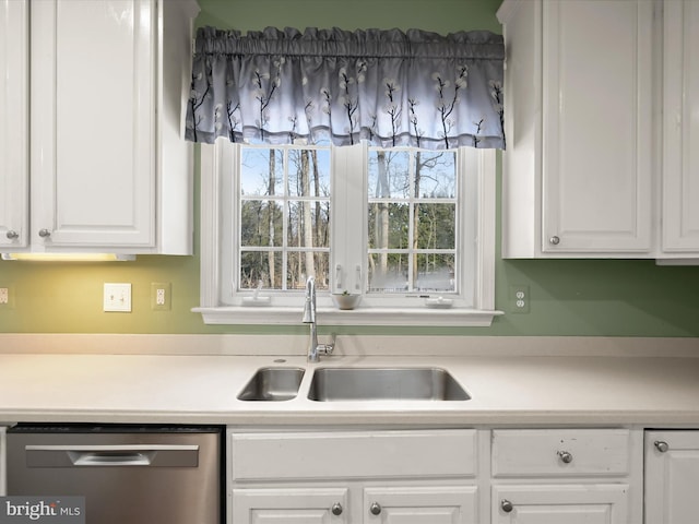 kitchen with white cabinets, dishwasher, and sink