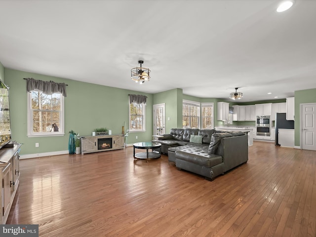 living room featuring light hardwood / wood-style flooring and a chandelier