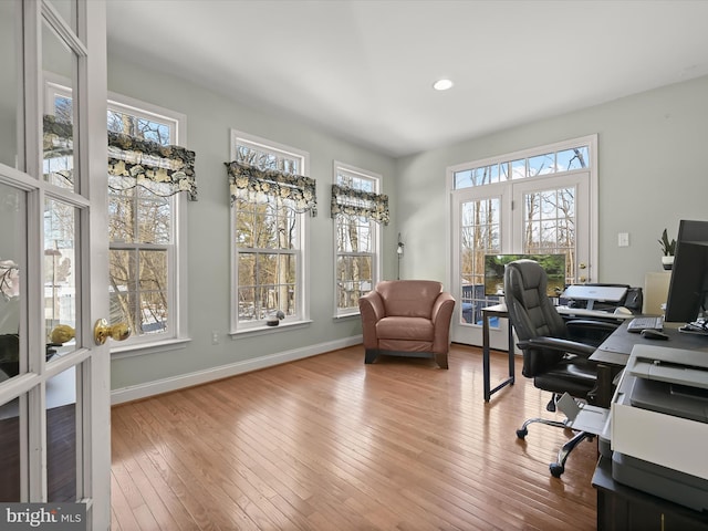 office space with a notable chandelier and light wood-type flooring