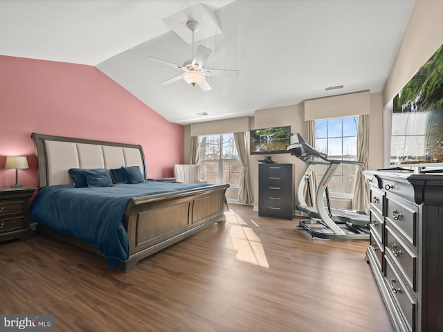 bedroom with ceiling fan, vaulted ceiling, and hardwood / wood-style flooring